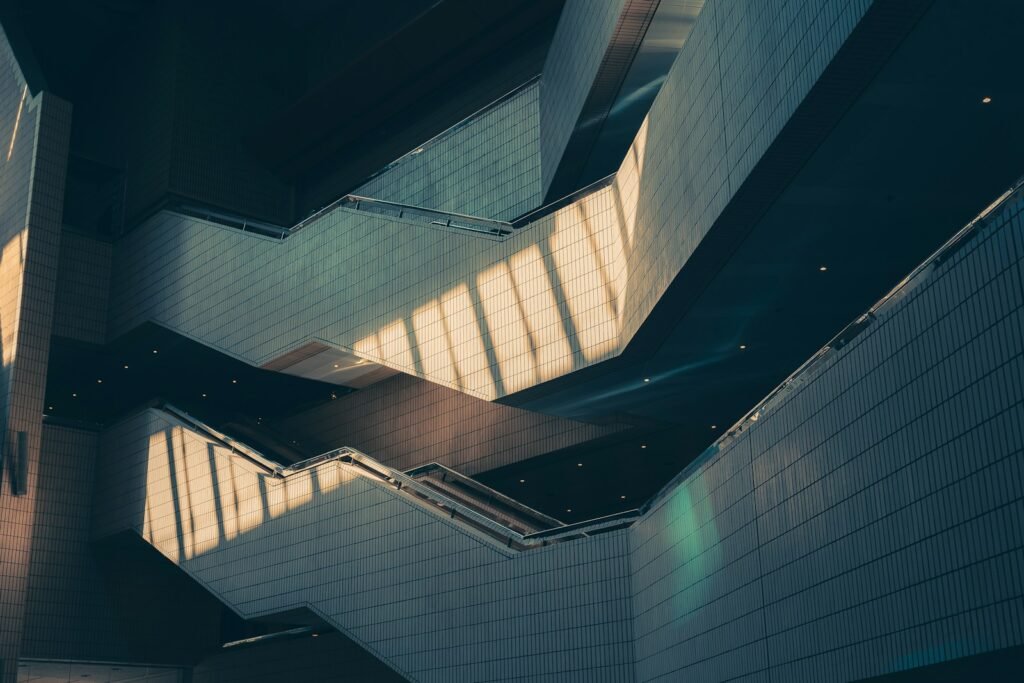 Sunlight falling across a geometric staircase inside a modern building